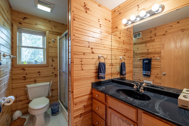 full bathroom with toilet, a stall shower, wood walls, vanity, and tile patterned flooring