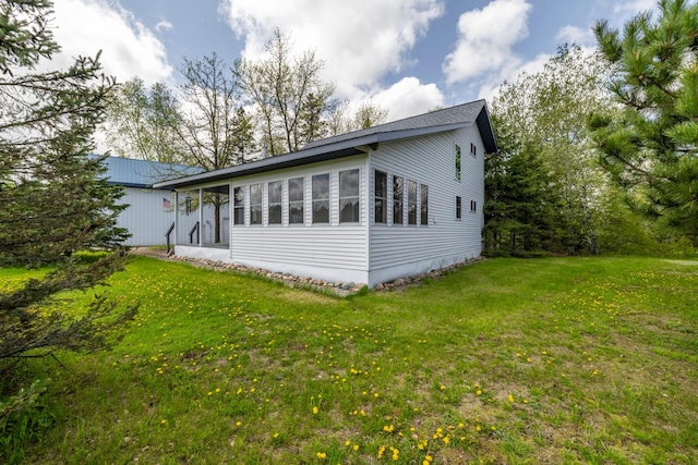 view of side of property featuring a yard