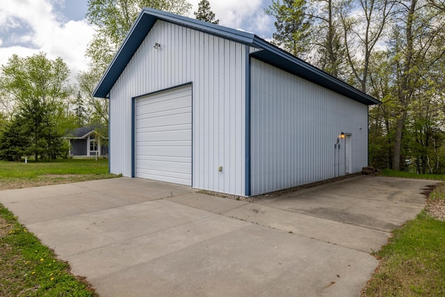 detached garage with concrete driveway