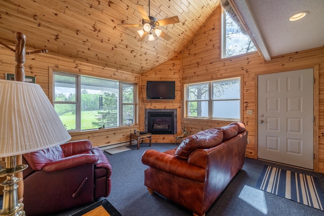 living area with carpet floors, wood walls, high vaulted ceiling, and a large fireplace