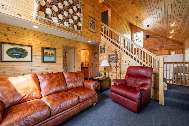 living area with carpet floors, stairway, wooden ceiling, and wooden walls