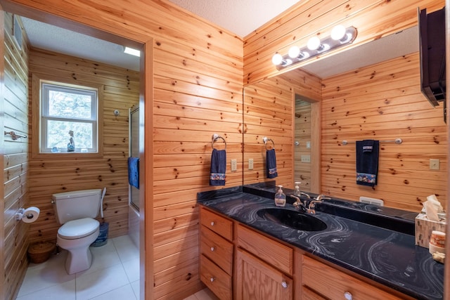 bathroom with a textured ceiling, tile patterned flooring, toilet, shower / bath combination with glass door, and vanity