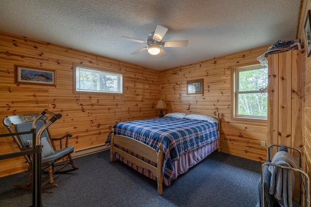 bedroom featuring multiple windows, dark colored carpet, and a textured ceiling