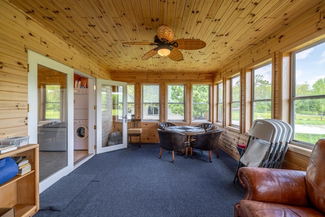 sunroom featuring washer / clothes dryer, wood ceiling, and a ceiling fan