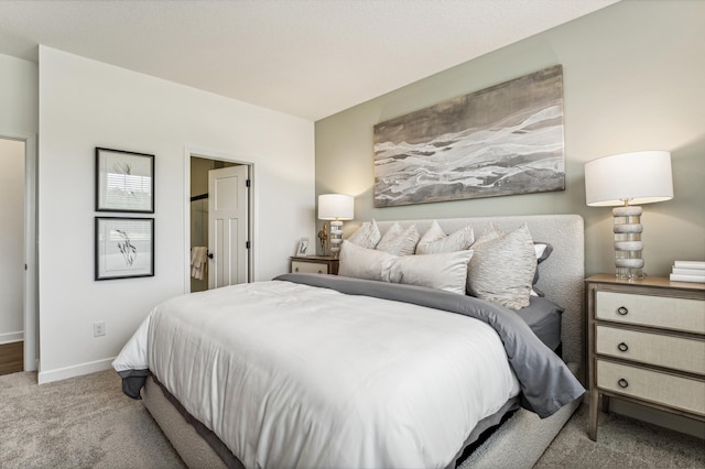 bedroom featuring light carpet and baseboards