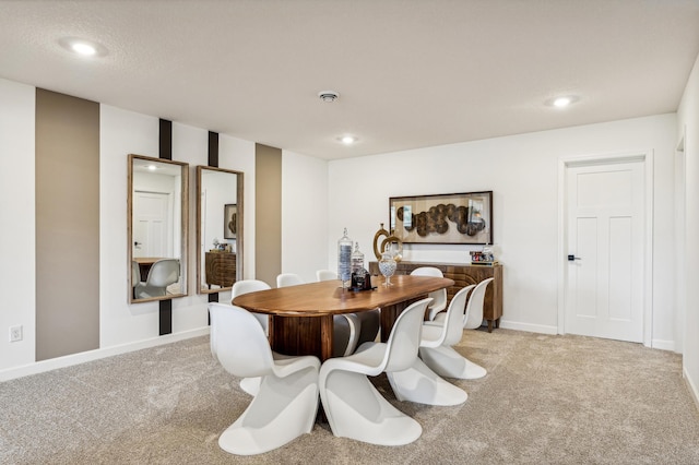 dining room featuring recessed lighting, light colored carpet, and baseboards