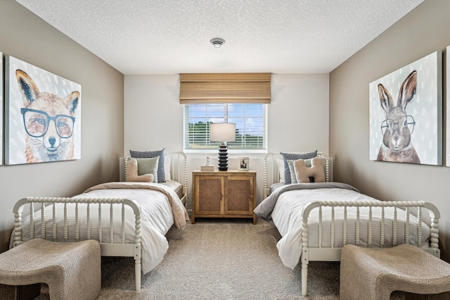 bedroom with a textured ceiling and light colored carpet