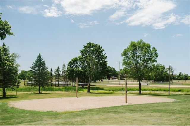 view of home's community with a lawn and volleyball court