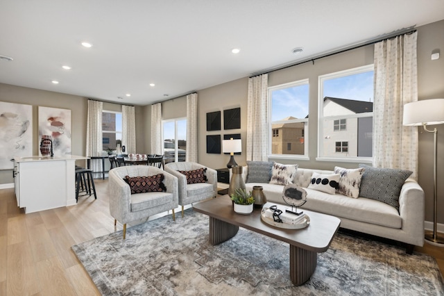 living room featuring light wood-type flooring, a wealth of natural light, and recessed lighting