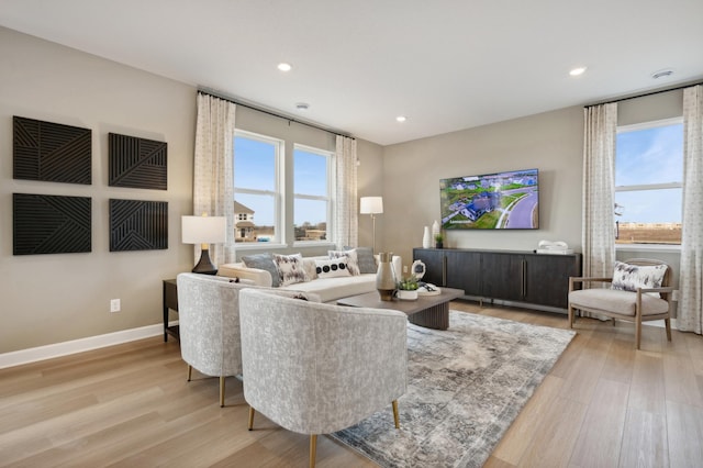 living area featuring recessed lighting, wood finished floors, and baseboards