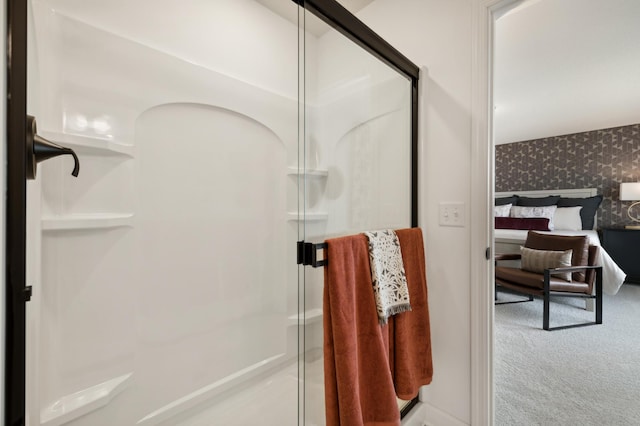 bathroom featuring a shower stall and wallpapered walls