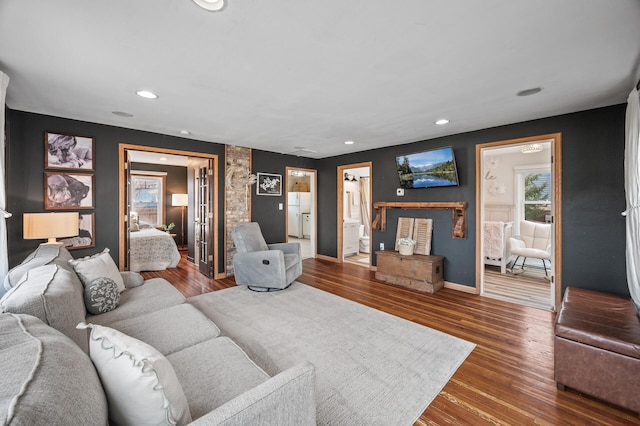 living area with recessed lighting, baseboards, and wood finished floors