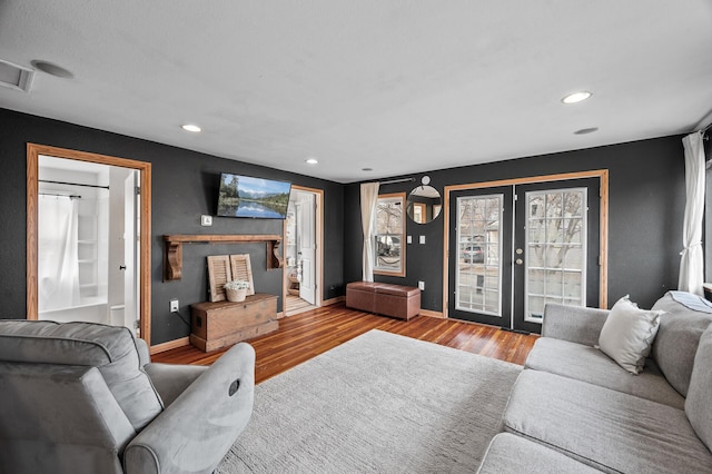 living area featuring recessed lighting, french doors, baseboards, and wood finished floors