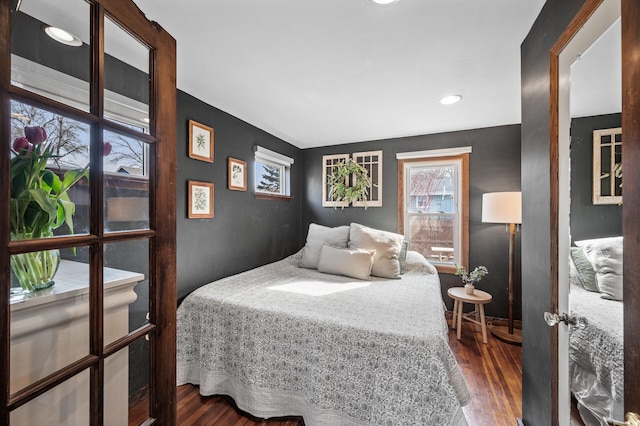 bedroom with wood finished floors and baseboards