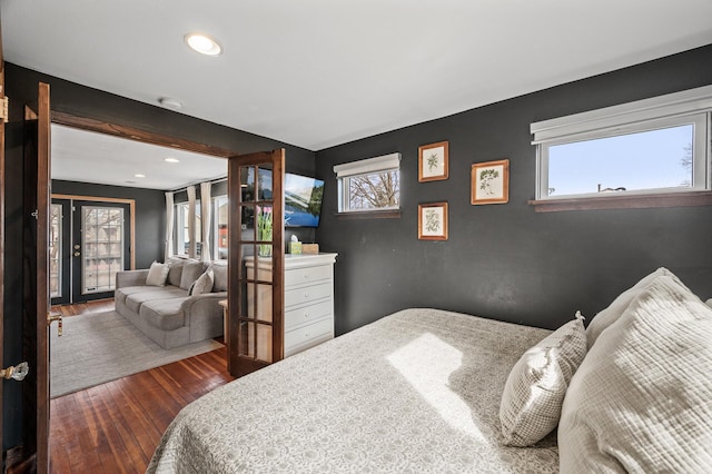 bedroom featuring hardwood / wood-style floors, beam ceiling, and recessed lighting