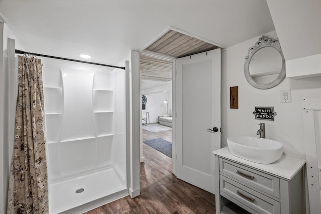 full bath featuring curtained shower, wood finished floors, and vanity