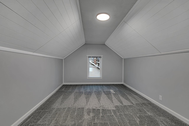 bonus room with lofted ceiling, carpet, and baseboards