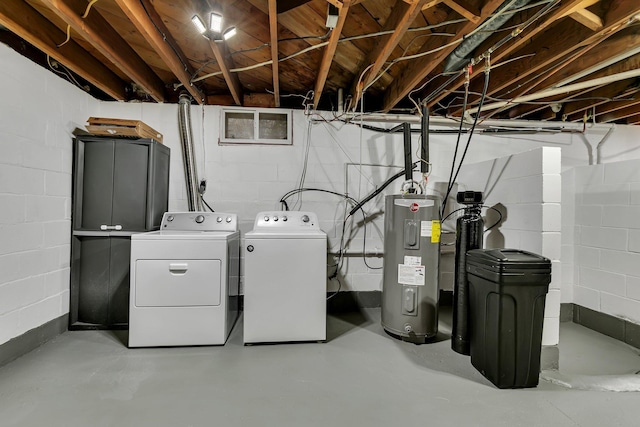 clothes washing area featuring laundry area, water heater, and independent washer and dryer