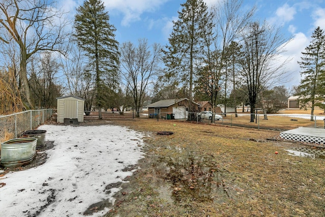 view of yard featuring a storage shed, an outdoor structure, and fence private yard