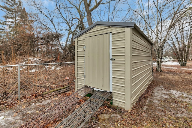 view of shed featuring fence