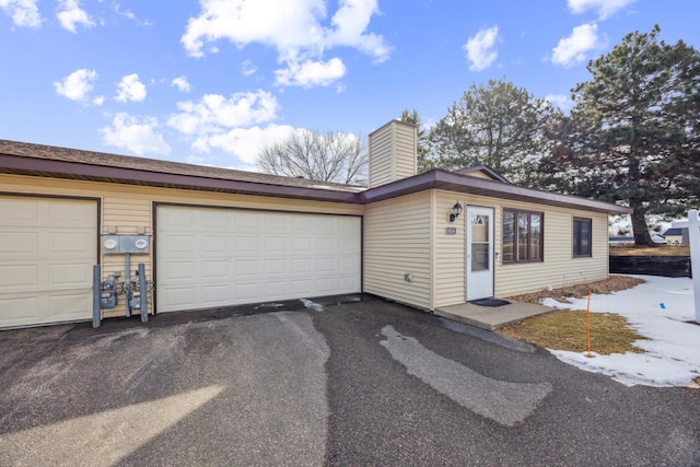 ranch-style house with aphalt driveway