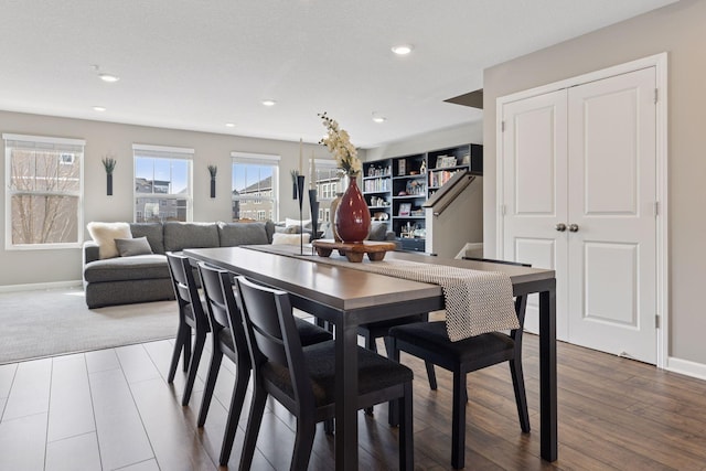 dining space with recessed lighting, stairs, baseboards, and wood finished floors