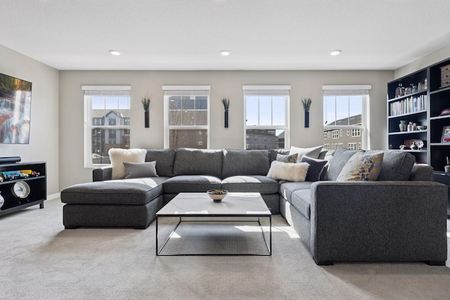 carpeted living room with recessed lighting and plenty of natural light