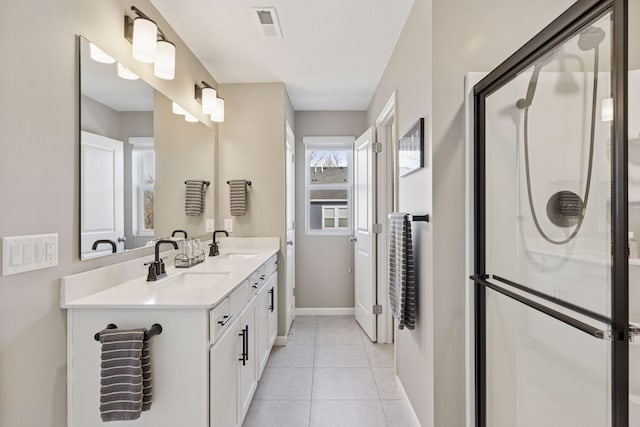 full bathroom with tile patterned flooring, a shower stall, visible vents, and a sink