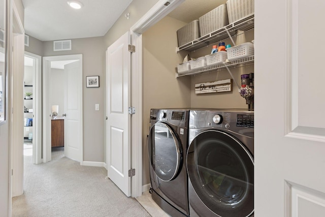 washroom featuring visible vents, independent washer and dryer, baseboards, light colored carpet, and laundry area