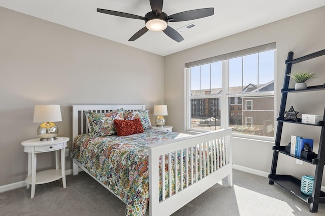 carpeted bedroom with baseboards and a ceiling fan