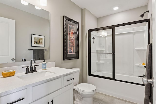 full bathroom featuring tile patterned flooring, toilet, vanity, and bath / shower combo with glass door