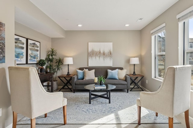 living area featuring visible vents, recessed lighting, and baseboards