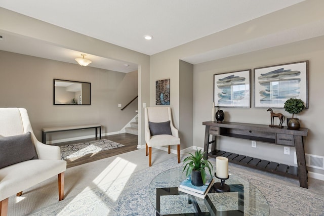 sitting room with visible vents, baseboards, stairway, recessed lighting, and wood finished floors