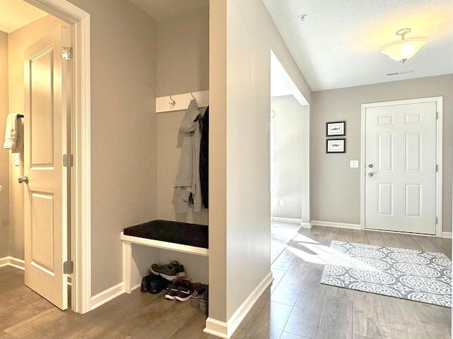 mudroom featuring baseboards and wood finished floors