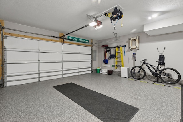 garage with electric panel and a garage door opener