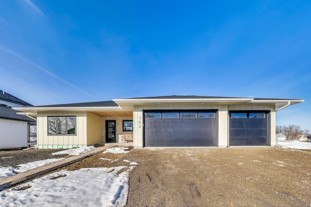 702 Summer Ave SE, New Prague, MN 56071 - view of front facade featuring driveway and board and batten siding