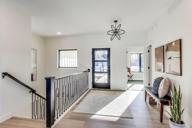 702 Summer Ave SE, New Prague, MN 56071 - entryway featuring a chandelier, visible vents, and wood finished floors