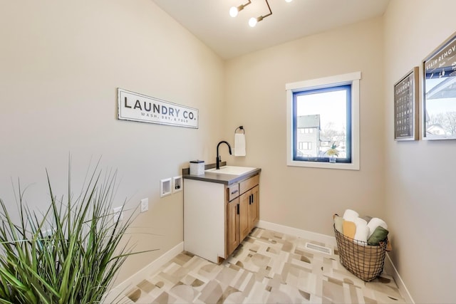 702 Summer Ave SE, New Prague, MN 56071 - laundry area with cabinet space, hookup for a washing machine, baseboards, and a sink