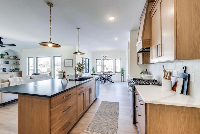 702 Summer Ave SE, New Prague, MN 56071 - kitchen with tasteful backsplash, open floor plan, a center island with sink, appliances with stainless steel finishes, and a sink