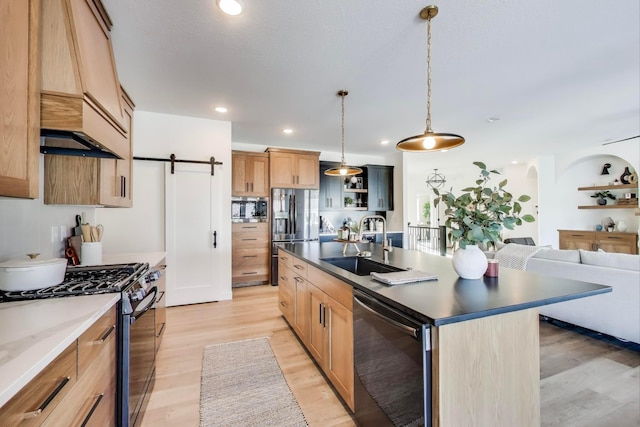 702 Summer Ave SE, New Prague, MN 56071 - kitchen with dark countertops, light wood-type flooring, recessed lighting, appliances with stainless steel finishes, and a sink