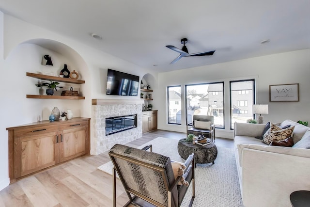 702 Summer Ave SE, New Prague, MN 56071 - living room featuring a fireplace, light wood-type flooring, and ceiling fan