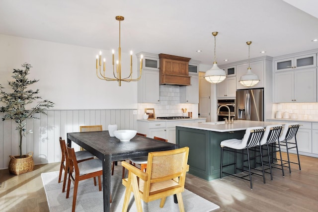 dining space featuring a chandelier, recessed lighting, and light wood-style floors