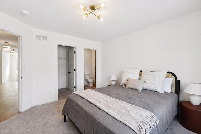 bedroom with light carpet, baseboards, a spacious closet, and visible vents