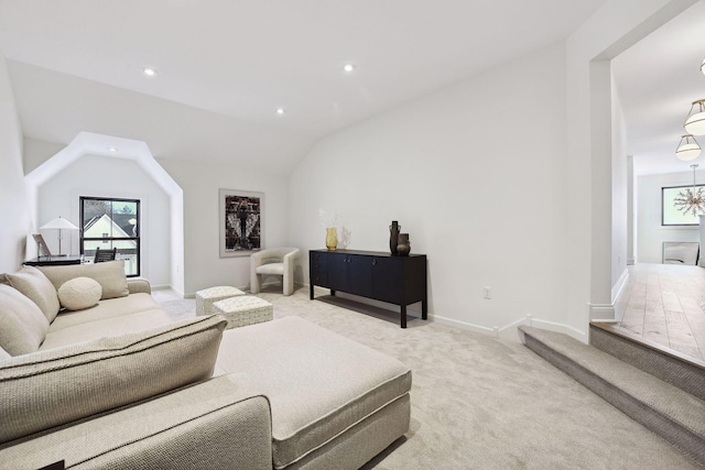 living room with lofted ceiling, recessed lighting, baseboards, and light colored carpet