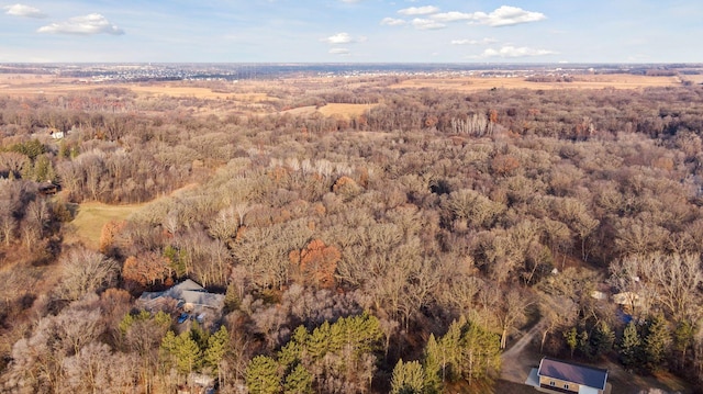 birds eye view of property featuring a view of trees