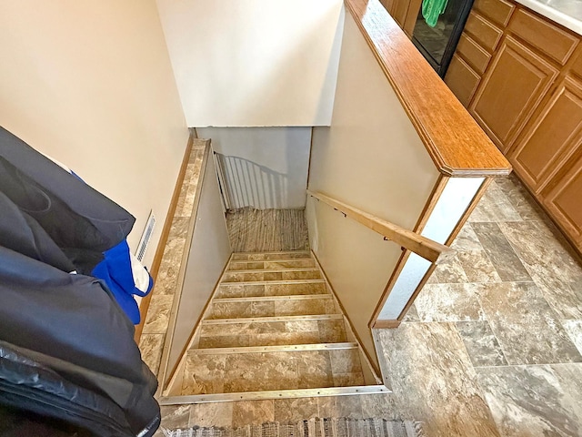 stairs featuring stone finish floor