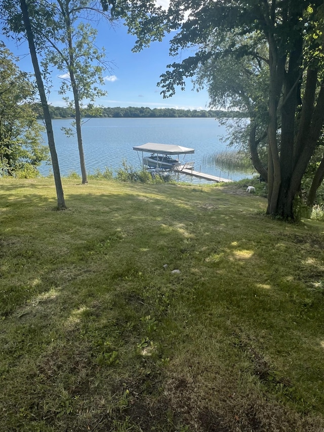 view of dock featuring a yard and a water view