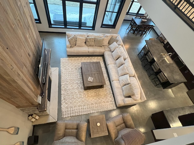 living area featuring plenty of natural light and concrete flooring