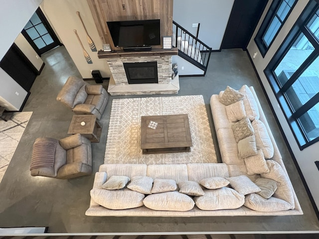 living area featuring stairs and a fireplace