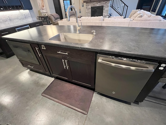 kitchen featuring a sink, dishwasher, and open floor plan